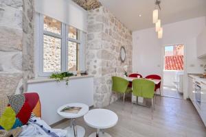 a kitchen and a dining room with a table and chairs at Festa Apartments in Dubrovnik
