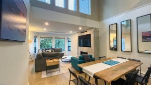 a dining room and living room with a table and chairs at 3BR Stunning Recently Renovated Condo by Harmony Whistler in Whistler