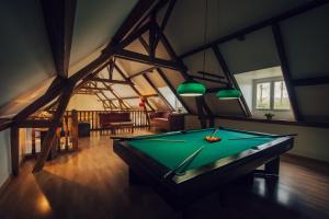 a pool table in the middle of a room at Clos Celeste - campagne d Etretat avec piscine et spa in Écrainville