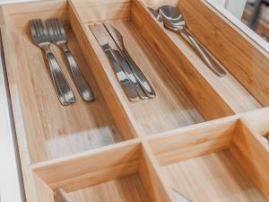 a wooden drawer with cutlery on top of it at Residential Hotels Helsinki Center in Helsinki