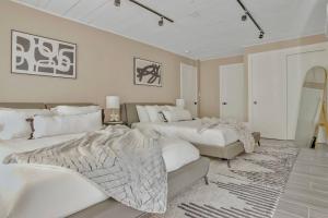 a bedroom with two beds and a rug at Stunning 2 Story Villa with Pool in Fort Lauderdale