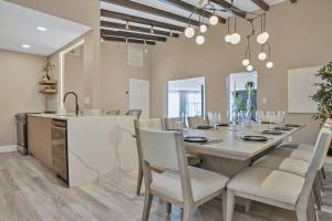 a kitchen and dining room with a table and chairs at Stunning 2 Story Villa with Pool in Fort Lauderdale