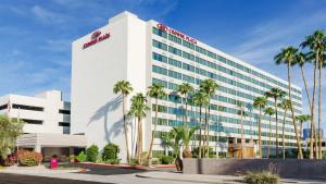 an office building with palm trees in front of it at Crowne Plaza Phoenix Airport - PHX by IHG in Phoenix