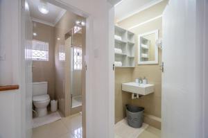 a bathroom with a toilet and a sink at Durban Overport Halaal Accommodation "No Alcohol Strictly Halaal No Parties" Entire Luxury Apartment, 3 Bedrooms, 6 Sleeper, Self Catering "300m from Musjid Al Hilaal" in Durban