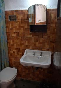 a bathroom with a sink and a toilet at Alojamientos en Cosquín in Cosquín
