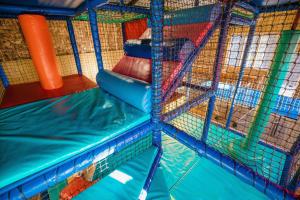 a play room with a slide and a inflatable slidektopktop at Orchard Cottage - Rudge Farm Cottages in Bridport