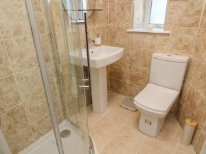 a bathroom with a toilet and a sink and a shower at The Bay Cottage - Morecambe Bay in Morecambe +25 photos