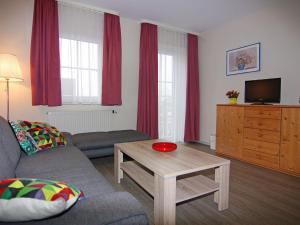 a living room with a couch and a table at Apartment for vier Personen in Fehmarn - Orth in Orth