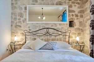 a bedroom with a bed and a mirror on the wall at Festa Apartments in Dubrovnik