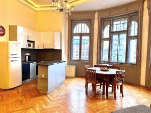 a kitchen with a table and chairs in a room at F14 Guest house by Small Home Budapest in Budapest
