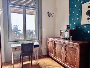 a desk and a chair in a room with a window at F14 Guest house by Small Home Budapest in Budapest