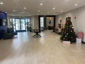 a christmas tree in the middle of a lobby at Holiday Inn Express Hotel & Suites Hermosa Beach, an IHG Hotel in Hermosa Beach