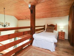 a bedroom with a bed in a log cabin at Threshers in Okehampton