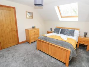 a bedroom with a large bed and a wooden door at Ty Melyn in Boncath
