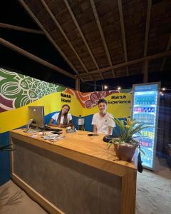 two people sitting at a desk with a computer at MAKTUB PREA HOSTEL in Prea +76 photos