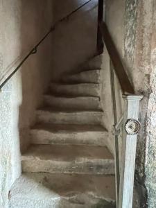 a set of stairs in an old building at La Manufacture Royale de Bains in Bains-les-Bains