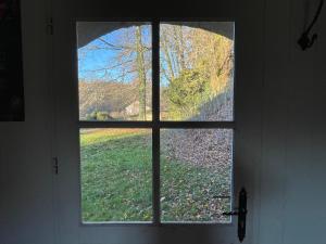 - une fenêtre dans une chambre avec vue sur un champ dans l'établissement La Manufacture Royale de Bains, à Bains-les-Bains