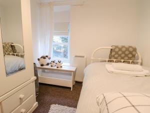 a bedroom with two beds and a window at 1 Llwyn Hir in Blaenau-Ffestiniog
