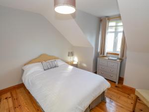 a bedroom with a white bed and a window at Home Farm Retreat in Williamstown