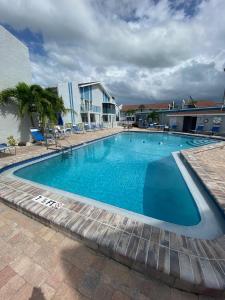 a large blue swimming pool in a building at Madeira Beach 2 Bedroom, 1 Bath 230 in St Pete Beach
