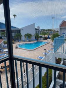 a view of a swimming pool from a balcony at Madeira Beach 2 Bedroom, 1 Bath 230 in St Pete Beach
