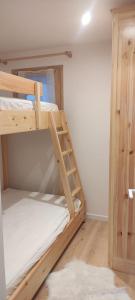 a room with two bunk beds and a ladder at T3 neuf 5 pers Serre Chevalier La Salle les Alpes in La Salle Les Alpes