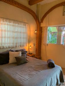 a bedroom with a large bed with a window at Oka Hey, Sayulita in Sayulita