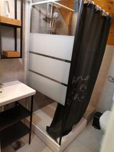 a shower curtain in a bathroom with a sink at Apartma PeMaks, Terme Olimia in Podčetrtek