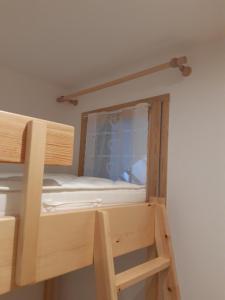a bunk bed with a window in a room at T3 neuf 5 pers Serre Chevalier La Salle les Alpes in La Salle Les Alpes