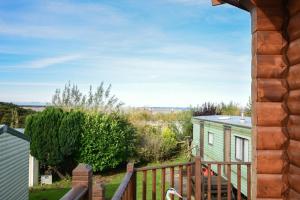 a view from the balcony of a tiny house at Heather Cottages - Grey Heron in Bamburgh