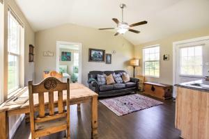 a living room with a couch and a table at Tranquil Plantersville Cabin Farm Animals On-Site in Magnolia