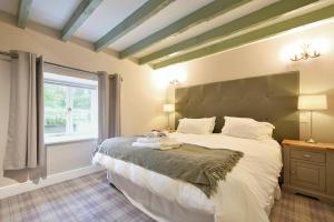 a bedroom with a large bed and a window at Millstone in Lucker