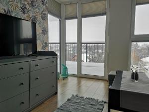 a living room with a tv on a dresser at Apartament dla Ciebie in Łańcut