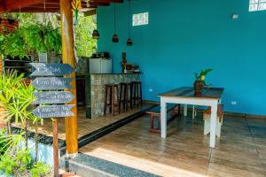 a dining room with a table and a blue wall at Suítes da Barra in Ubatuba +44 photos