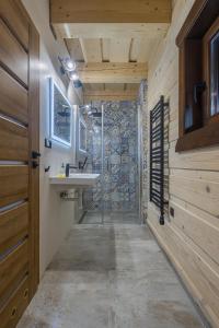 a bathroom with a sink and a shower at Drevenica Lesanka in Demanovska Dolina