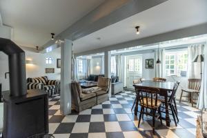 a living room with a fireplace and a table and chairs at Ferienhaus Strandgut in Oevenum