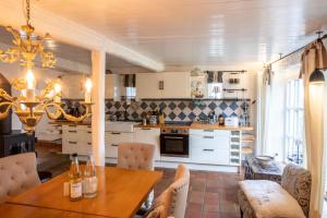 a kitchen with a table and a dining room at Ferienhaus Strandgut in Oevenum