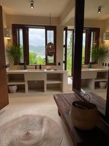 a bathroom with two sinks and a large mirror at Cabaña junto al mar in Zihuatanejo +30 photos