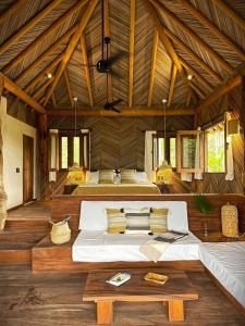 a bedroom with two beds in a room with wooden ceilings at Cabaña junto al mar in Zihuatanejo