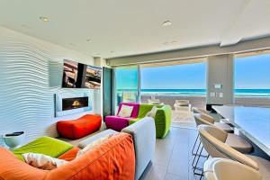 a living room with colorful furniture and a view of the ocean at Crown Jewel in Mission Beach at Ocean Front Walk in San Diego