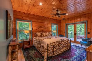 a bedroom with a bed and a ceiling fan at A River Mist Too in Sugar Grove