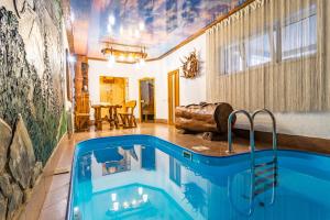 a pool in the middle of a living room at Villa Nikoletta in Bukovel