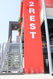 a red building with a sign that reads store at 2 REST 