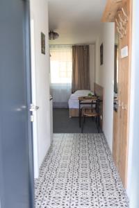 a hallway with a bedroom with a bed and a table at 2 REST 