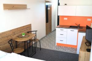 a small kitchen with a small table in a room at 2 REST in Soľ