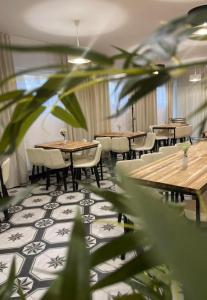 a restaurant with tables and chairs and a plant at 2 REST 