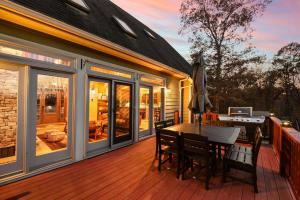 a wooden deck with a table and chairs on a house at Wisp'd Away in Swanton
