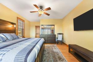 a bedroom with a bed and a ceiling fan at Wisp'd Away in Swanton