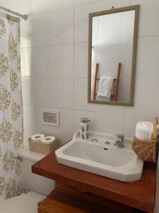 a bathroom with a sink and a mirror at Cabañas Koyam Ruka in Licán Ray