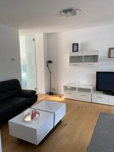 a living room with a couch and a coffee table at Appartement met groot terras in Mortsel